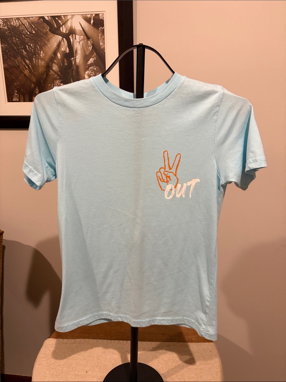 Thereabouts Light Blue Tee with Orange Peace Hand Graphic and Magellan red tee.